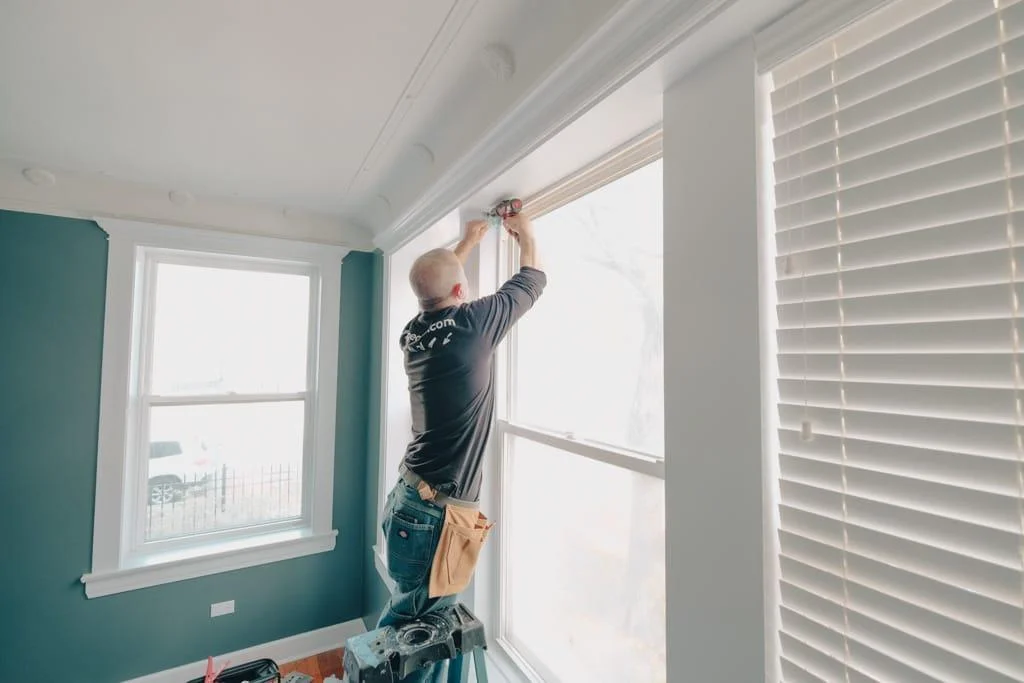 handyman working on home renovation windows